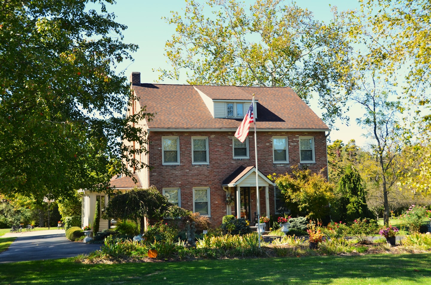 A traditional two-story brick house with a front porch
